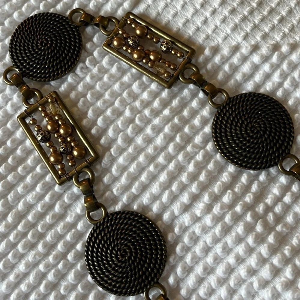 Women’s chain with metal circular and rectangular patterns belt.